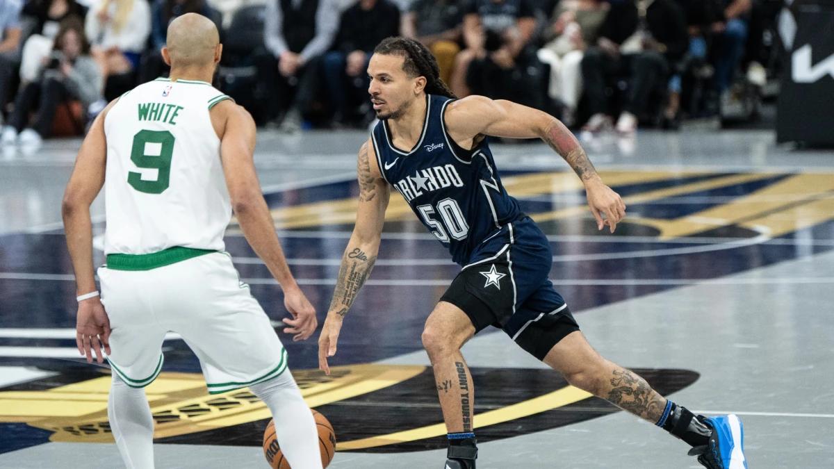 Orlando Magic guard Cole Anthony (50) drives past Boston Celtics guard Derrick White (9) in the team's win over the Celtics earlier this season